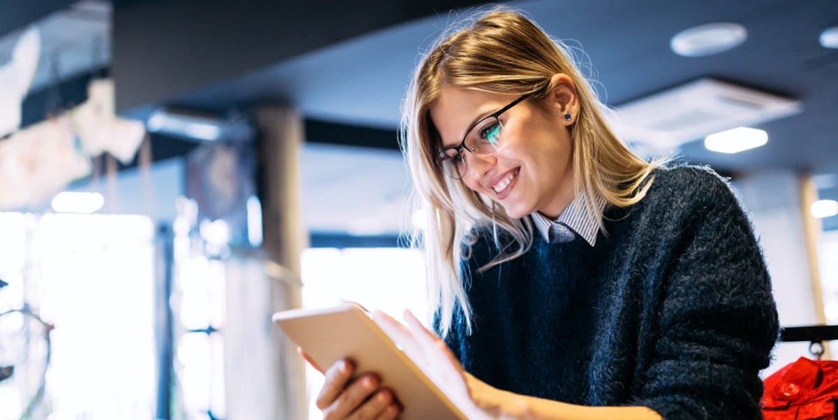 professional woman in office looking at a tablet