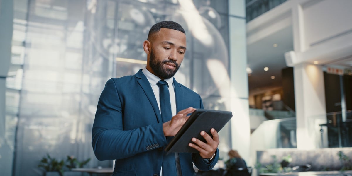 man in the office, looking at tablet