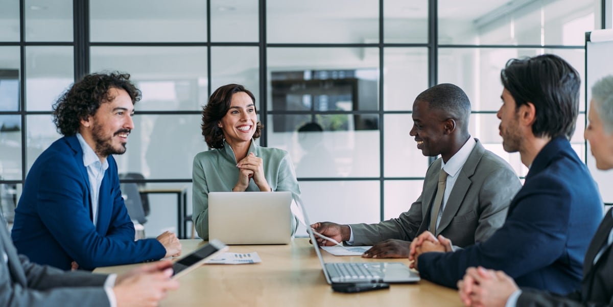 group of people sitting at a conference table